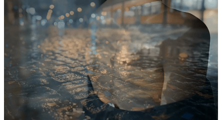 Wet cobblestones reflecting city lights in the rain