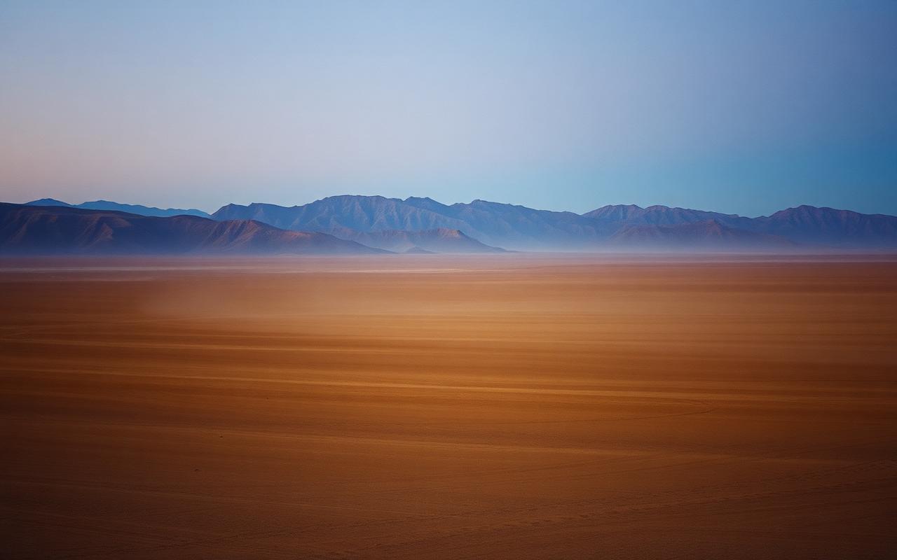 Vast steppe with distant mountains at dusk